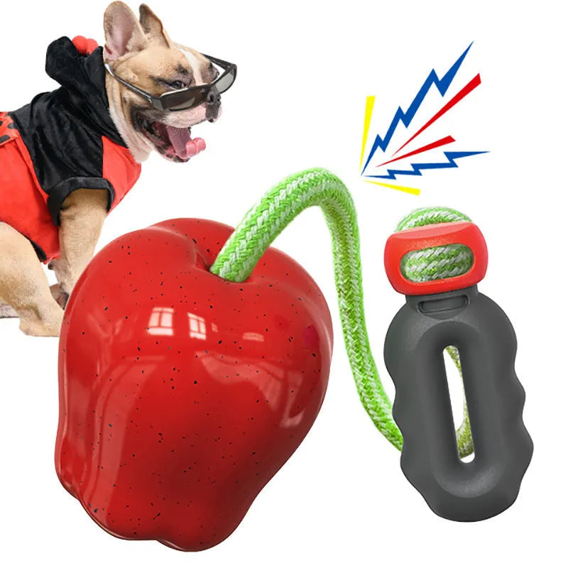 Green and red plastic apple-shaped dog toy with hollow centre for food dispensing