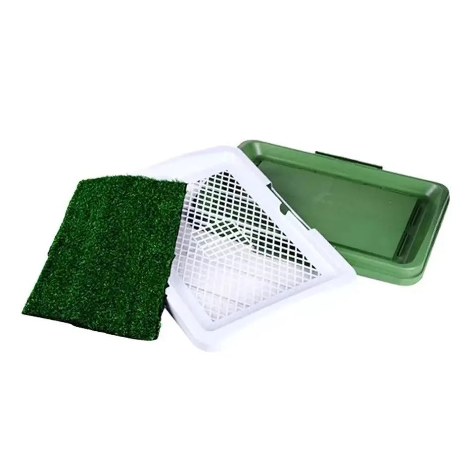 Green artificial turf dog toilet with removable plastic collection tray for indoor potty training.