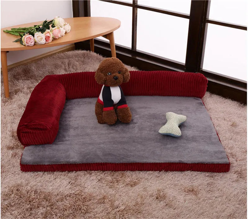 Corduroy dog sofa bed with bolster, shown in grey, placed on a wooden floor.