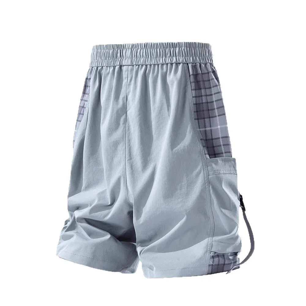 Man wearing loose-fit beige cargo shorts with visible plaid stitching detail on the legs.