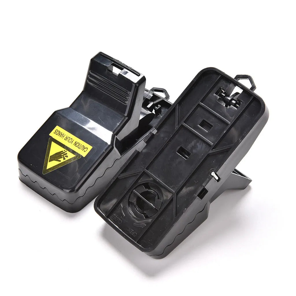 Six black plastic snapping mousetraps showing 11cm length and biting mechanism