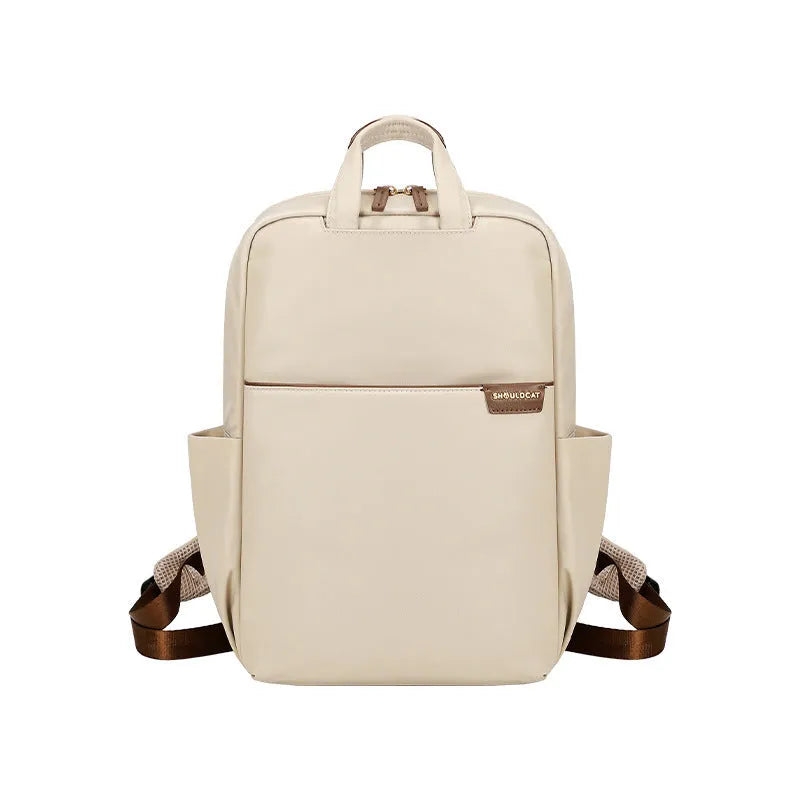 Women's canvas travel backpack in apricot colour showing external sandwich pockets and urban simplicity style.