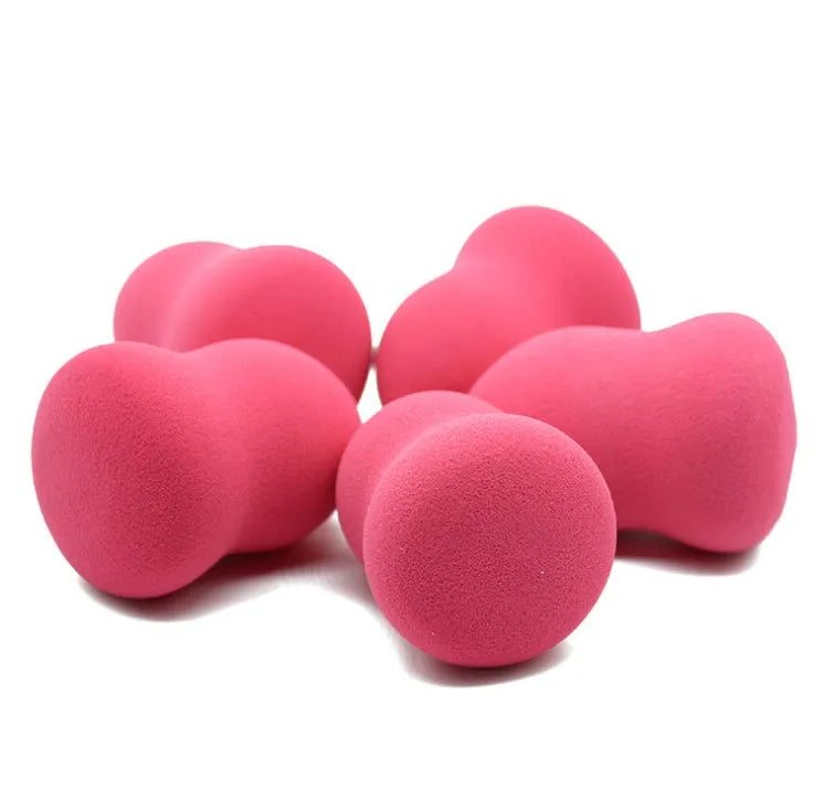 Pink cubic makeup foundation sponge puff on a clean surface.