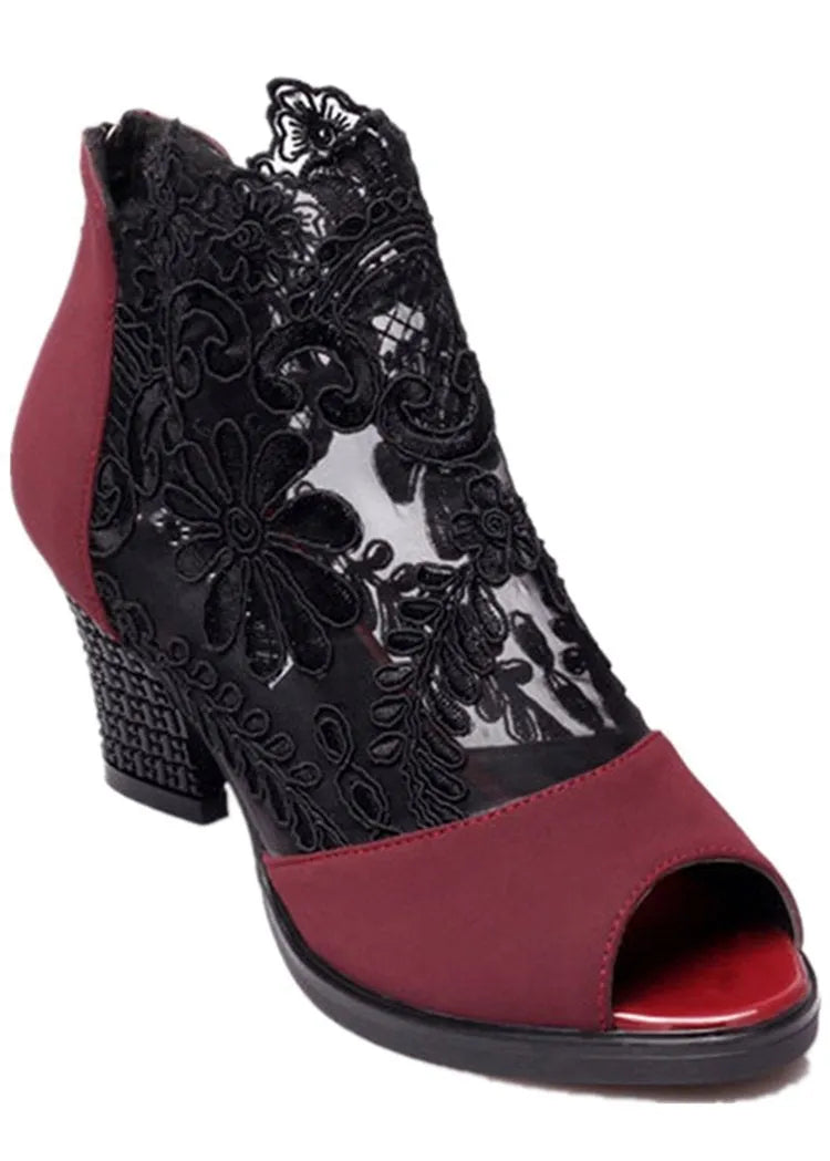 Black gladiator sandals with lace upper, square high heel, and zip closure on ankle
