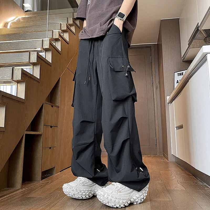 Plus size women's loose fit straight-leg waterproof trousers in black, grey, or white.