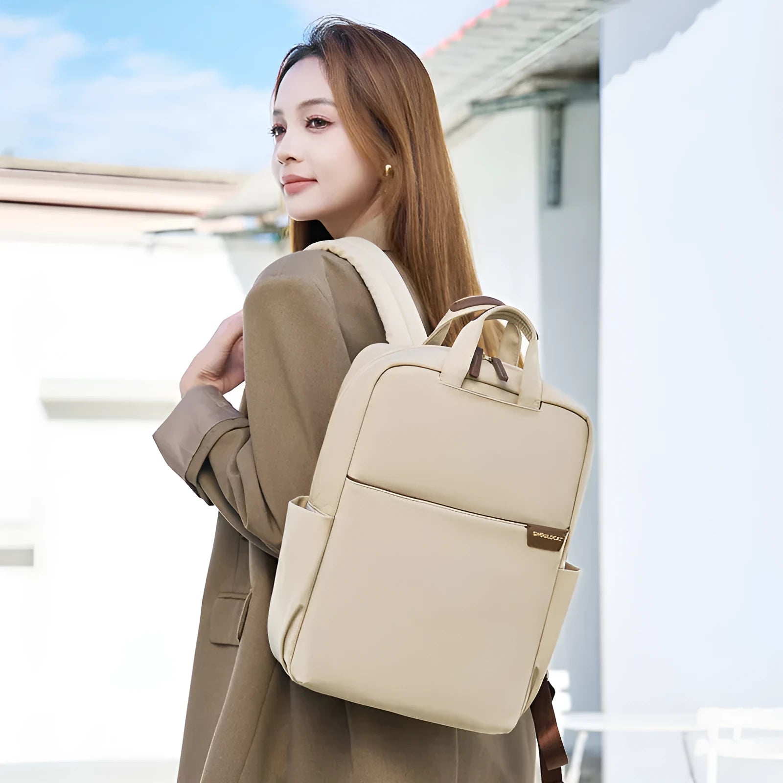 Women's canvas travel backpack in apricot colour showing external sandwich pockets and urban simplicity style.