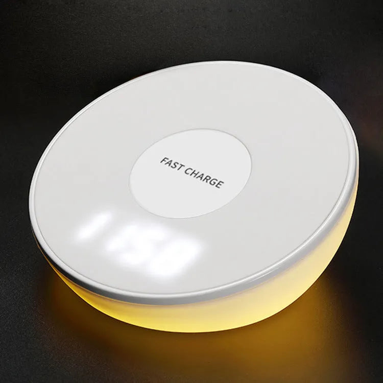White wireless smartphone charger with digital clock display and three control buttons on the front.