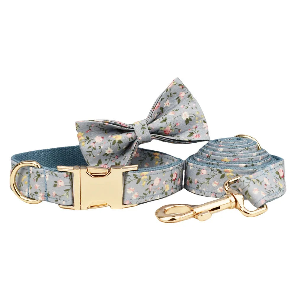 Blue floral patterned cloth dog collar with matching leash, vest, bow, and poop bag set for pet gifts