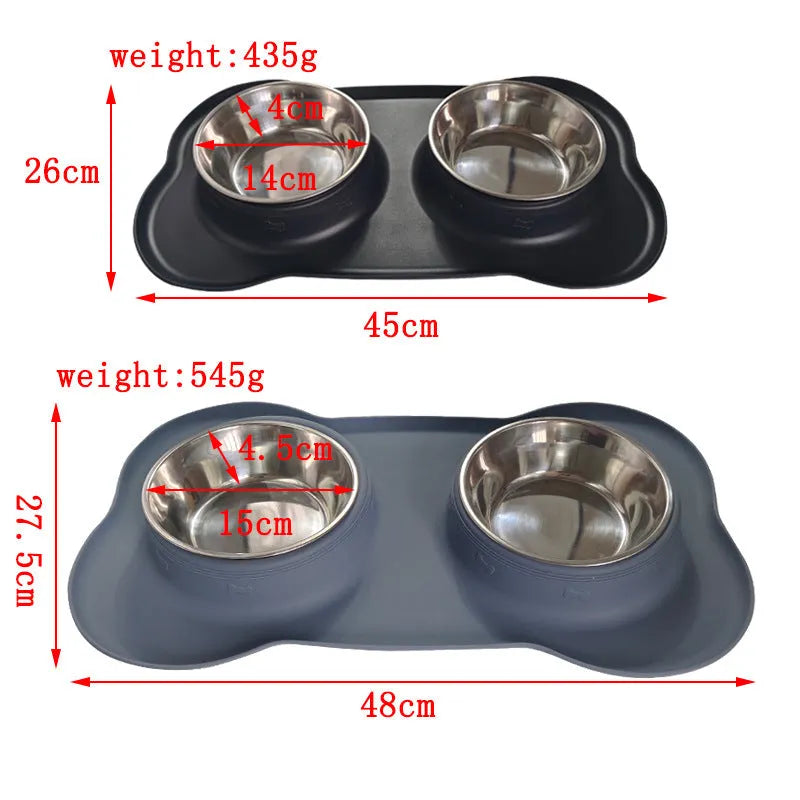 Large black silicone dog bowl sitting inside a stainless steel base, shown on a kitchen floor.