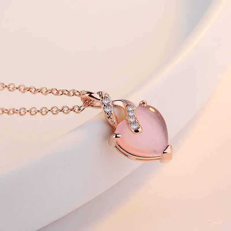 Women's heart-shaped pink crystal pendant necklace with rose gold cross chain