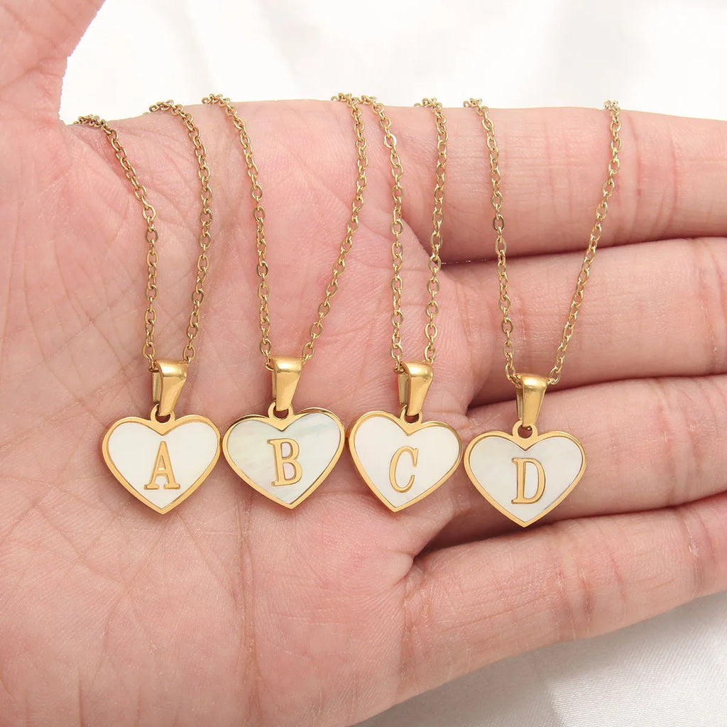 Gold-plated heart necklace with white shell accent and personalised letter pendant on stainless steel chain