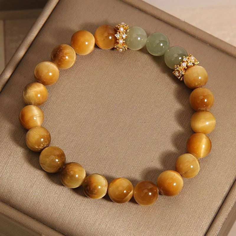 Natural Yellow Tiger's Eye and Hetian Jade beaded bracelet with gold gourd or bamboo joint design.