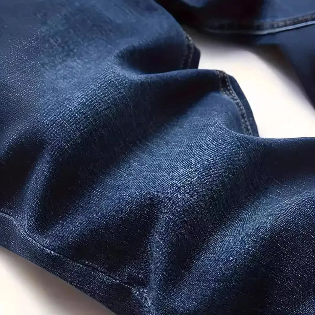 Dark blue men's slim-fit casual jeans with a worn finish and skinny leg opening.