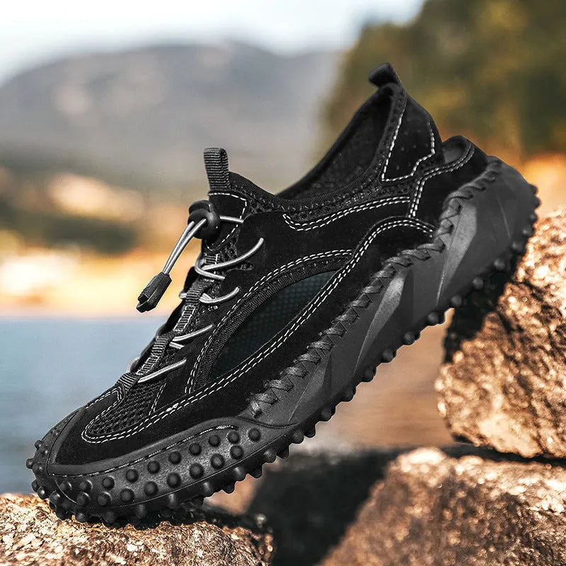 Men's black waterproof wading shoes with leather mesh upper, holes for drainage, and a rubber sole.
