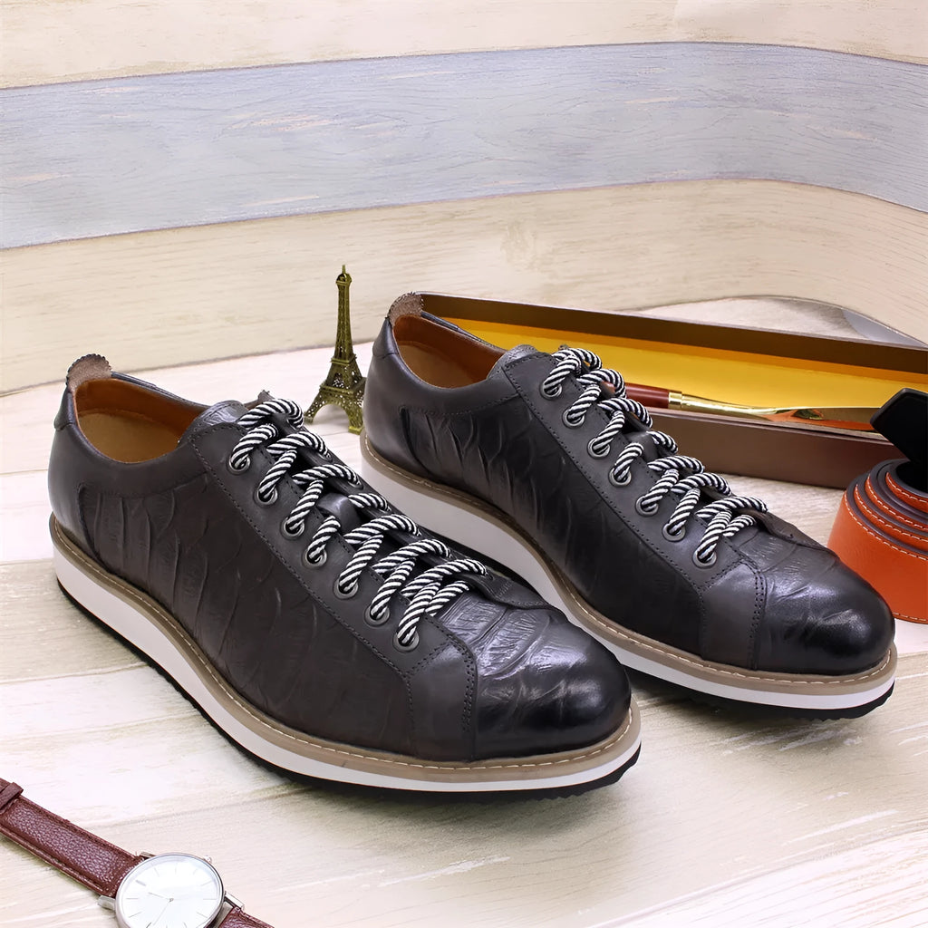 Men's white low-top sneakers with an embossed pattern and front lace-up closure.