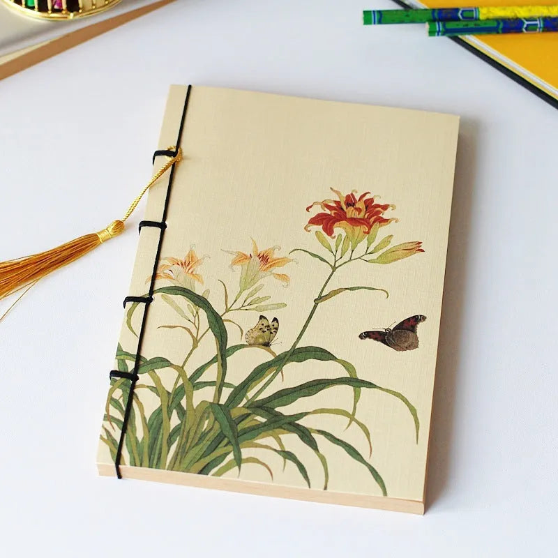 A5 antique wire-bound notebook with retro painting cover, thread binding, and black tassels.