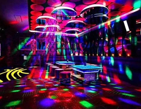 Black and white LED laser magic fan stage light with remote control on a stand.
