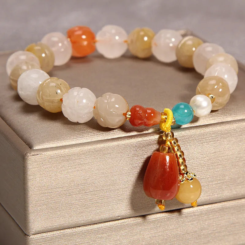 Women's yellow agate crystal beaded bracelet with gold silk thread and tassel.