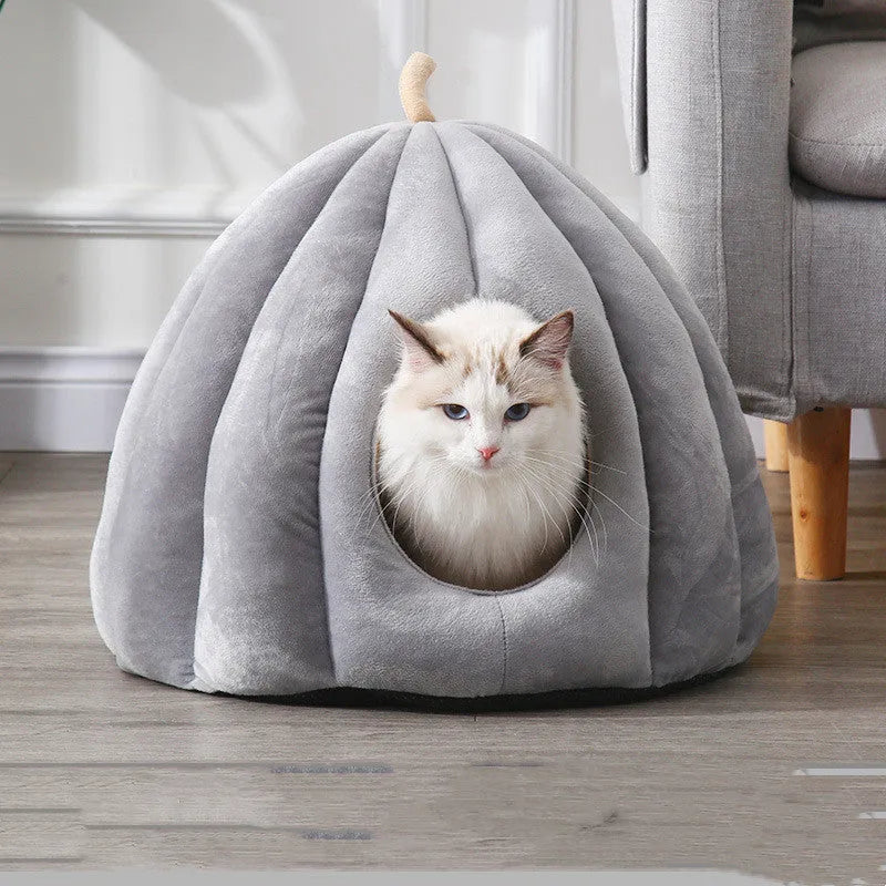Pumpkin-shaped winter pet bed in orange, closed cave design for cats and small dogs, soft coral fleece fabric.