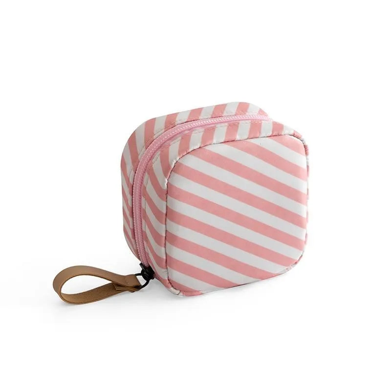 Plain cloth cube-shaped makeup storage bag shown in blue, pink, white, and white-pink colour options.