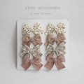 Set of eight fabric dovetail bow hairclips for children in various colours