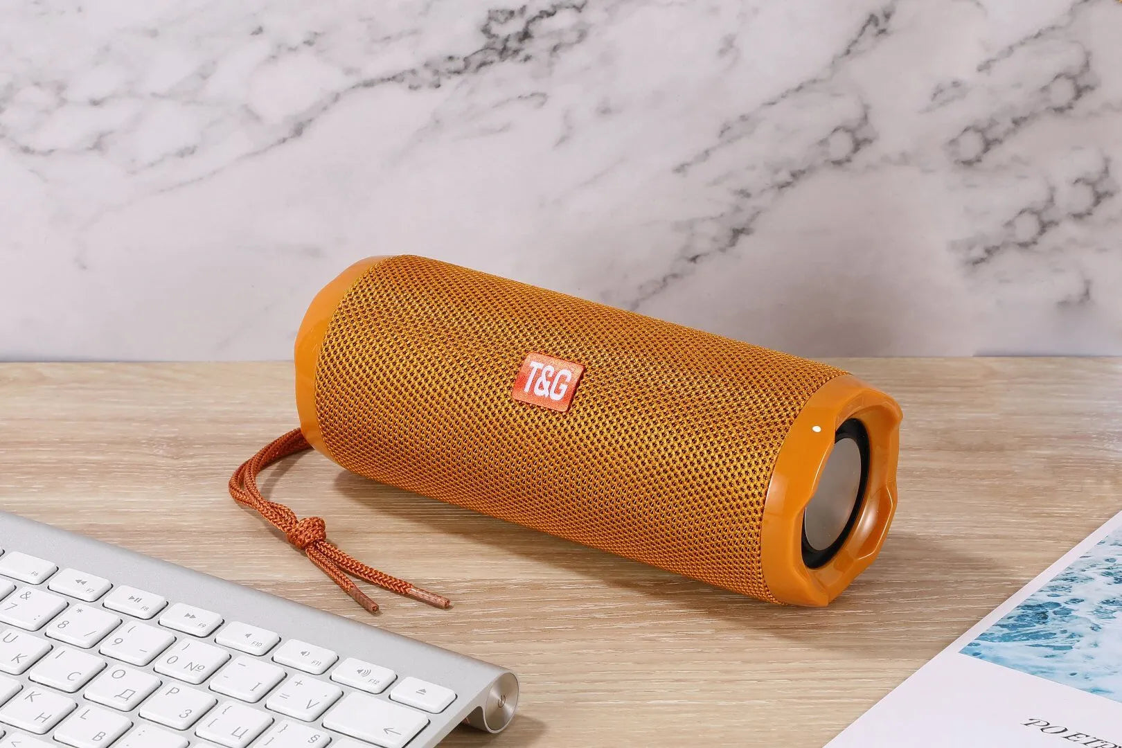 Fabric portable Bluetooth speaker with integrated card holder shown in multiple colour options.