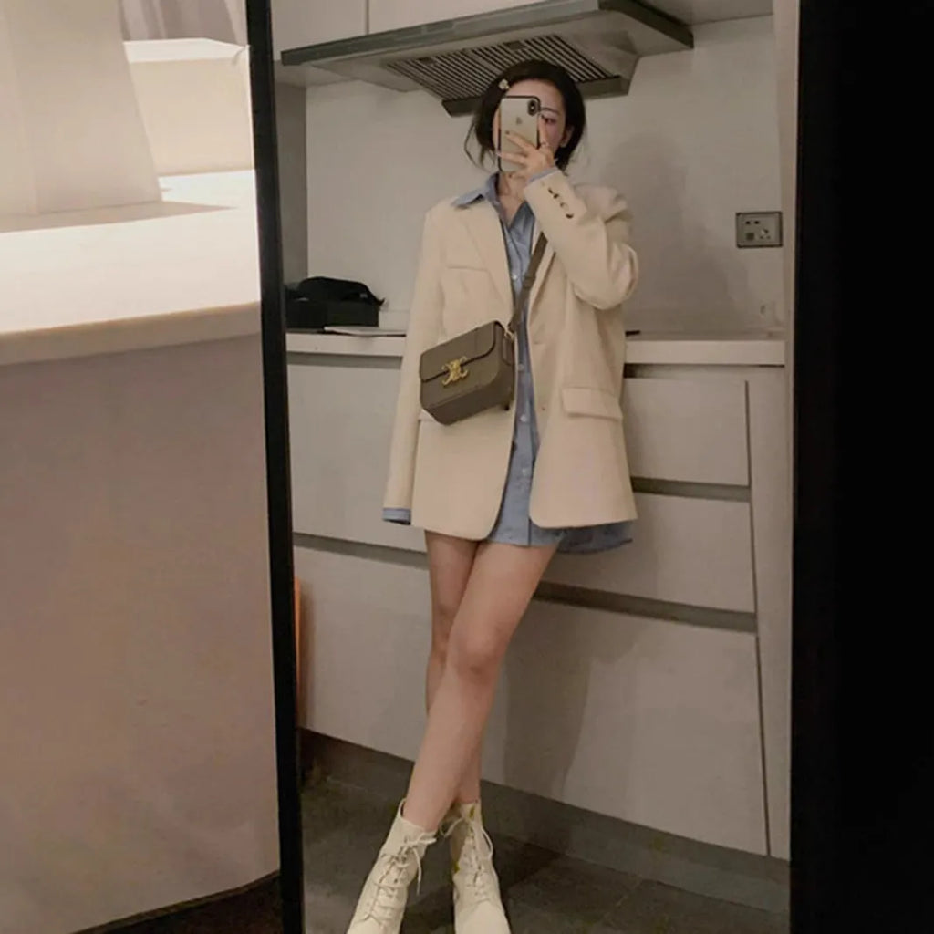 Korean style small suit jacket in polyester fabric, shown in milky white colour with long sleeves and pockets