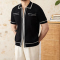 Man's black slim fit polo shirt with a lapel collar and short sleeves.