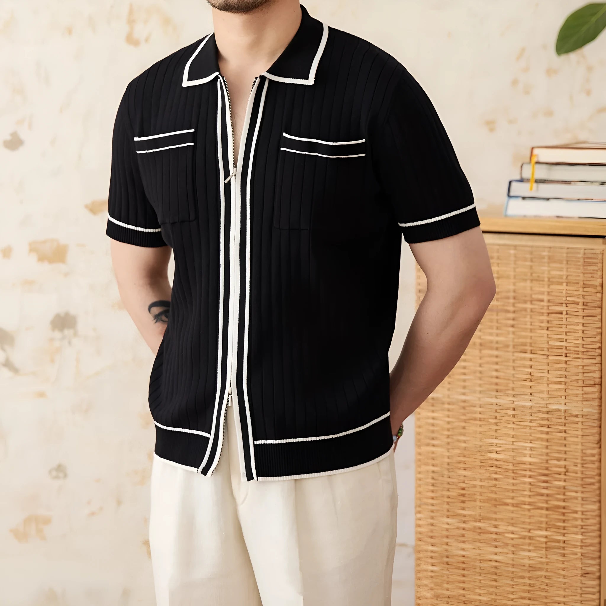 Man's black slim fit polo shirt with a lapel collar and short sleeves.