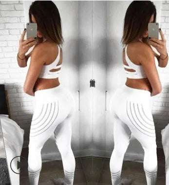 Women's black and white workout leggings with night glowing print, showing slim fit pencil pants style.