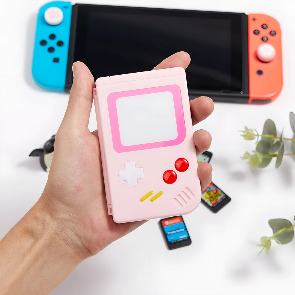 Blue Nintendo Switch game card storage box for SWITCH OLED LITE next to game cartridges.