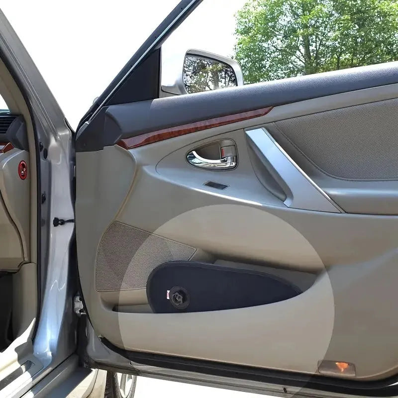 Black adjustable car window shade with suction cups stretched across vehicle side window