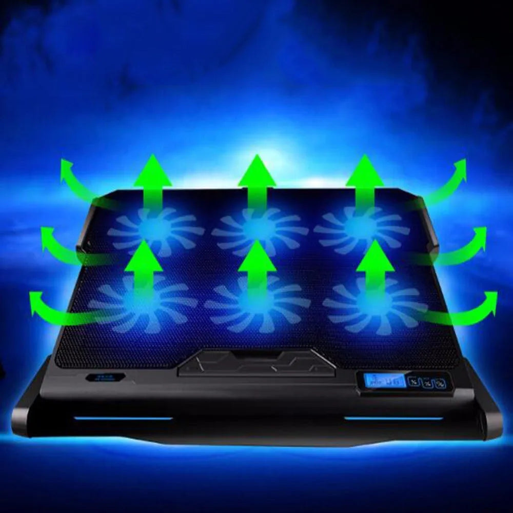 Black metal mesh laptop cooling board with a fan, placed under a notebook on a desk.