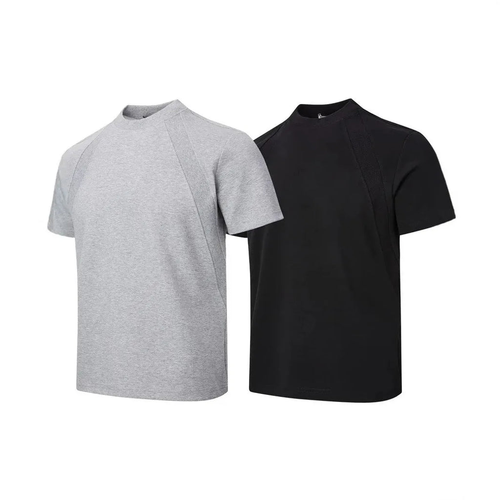 Man wearing a loose-fit black short-sleeve polyester top with air layer stitching.
