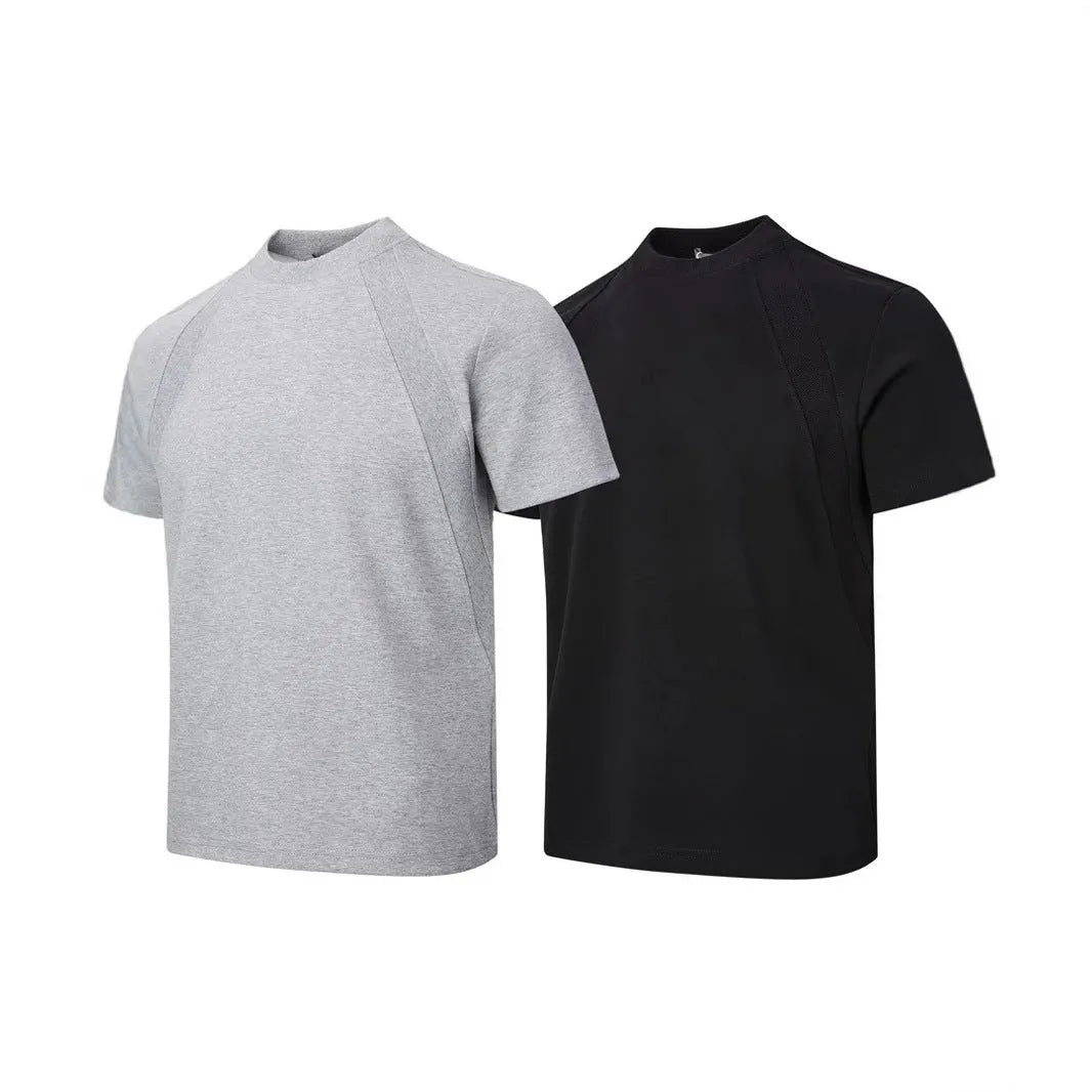 Man wearing a loose-fit black short-sleeve polyester top with air layer stitching.
