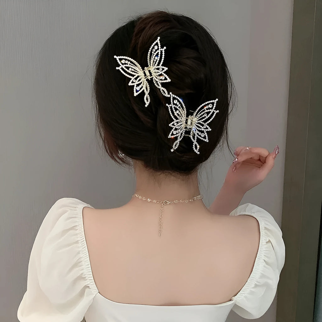 Butterfly-shaped alloy hair clip for women with electroplated finish, shown in rhinestone and pearl styles.