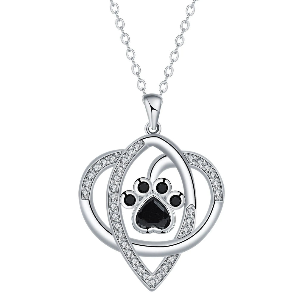 Close-up of a dog's paw print pendant necklace on a cross chain for women.