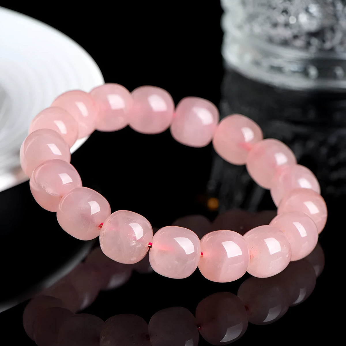 Natural pink crystal bead bracelet with geometric barrel-shaped design measuring 8-10mm per bead