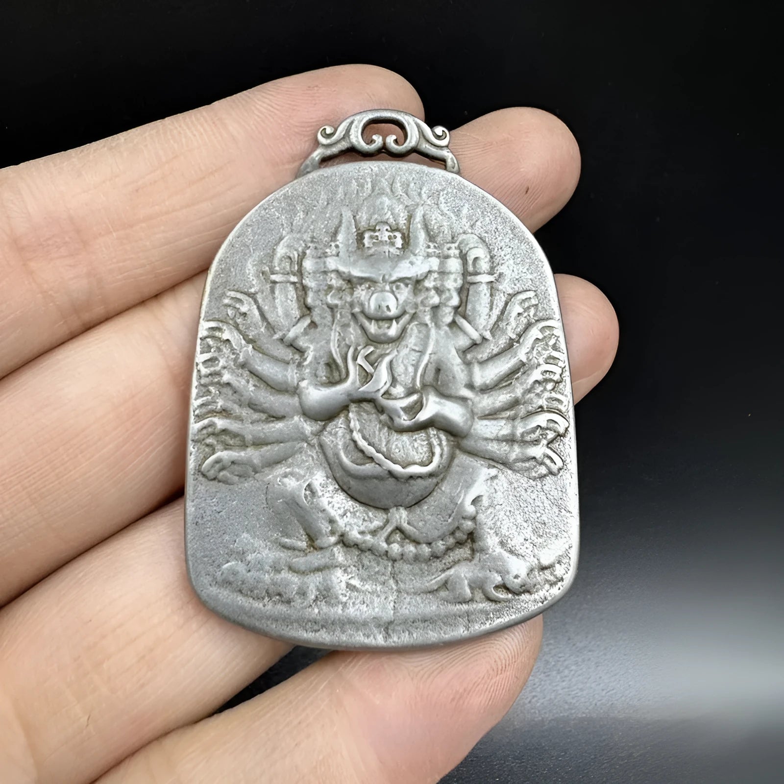 Close-up of iron Chinese style geometric pendant ornament featuring Aryaacalanatha Yamantaka motif.