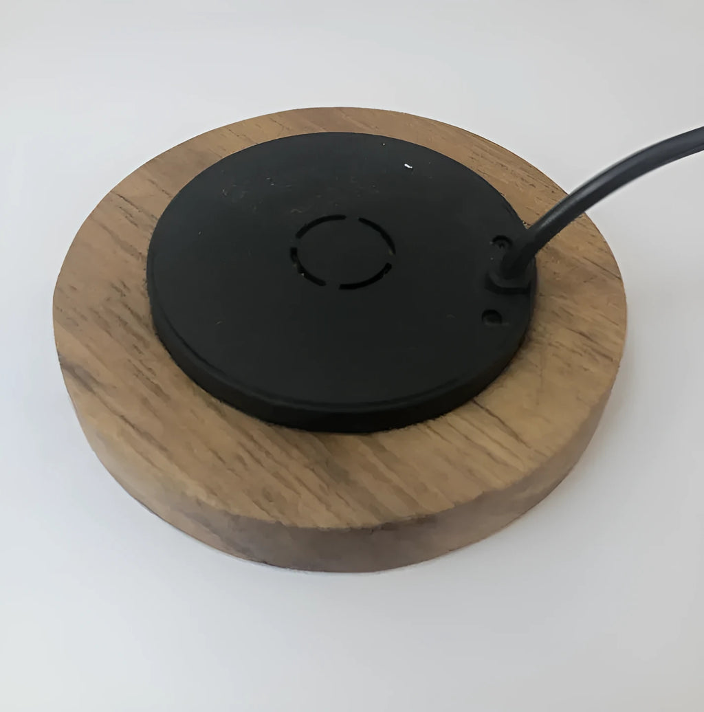 Round embedded wireless phone charger for installation in desks and furniture, shown with USB port.