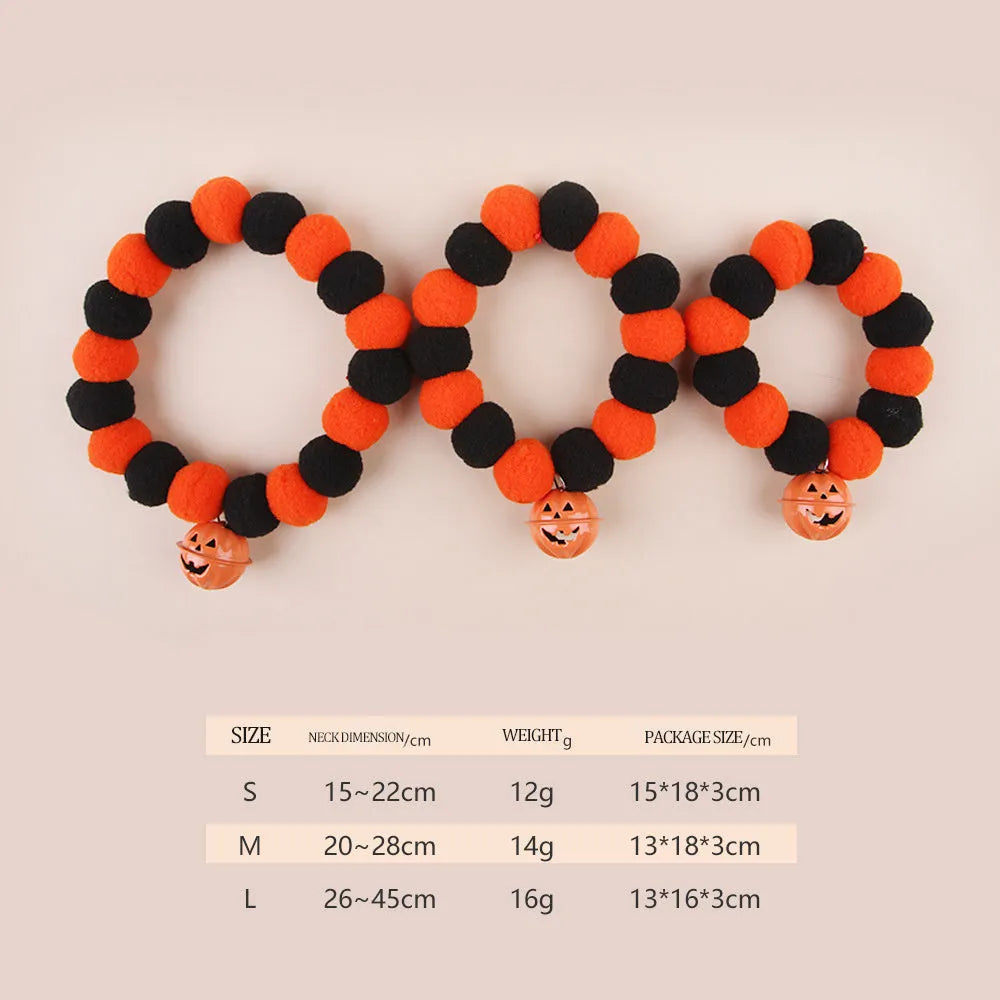 Orange Halloween cat collar with a pumpkin graphic and metal jingle bell on a black background.