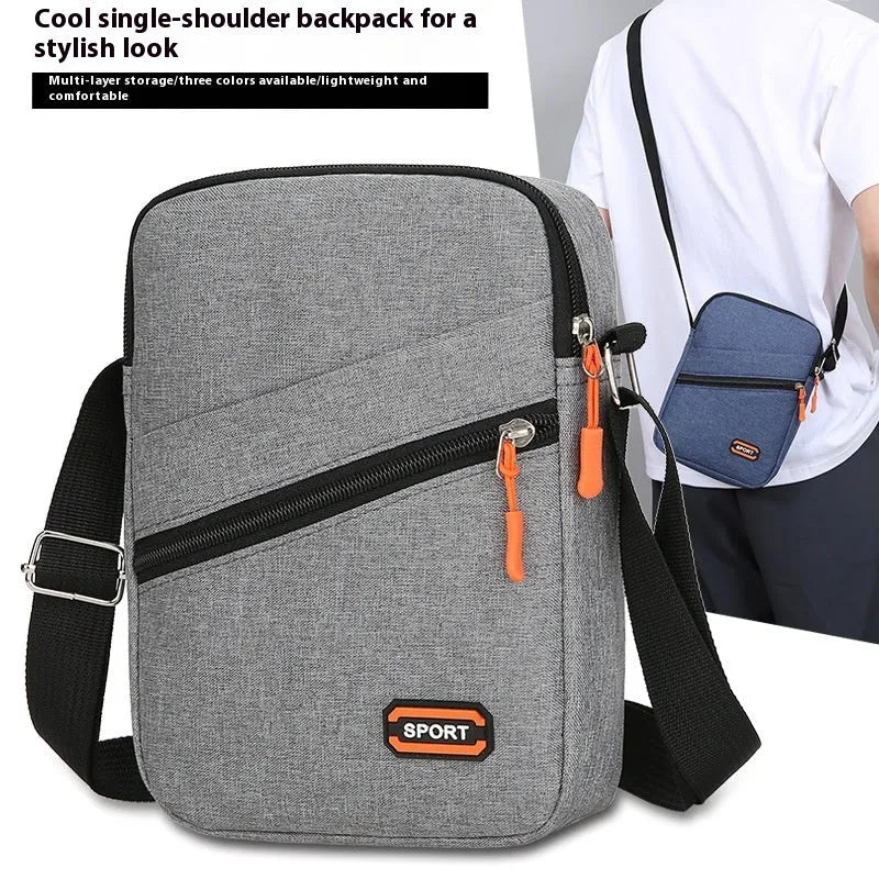 Solid colour Oxford cloth crossbody commuter bag with contrast details in silver grey.
