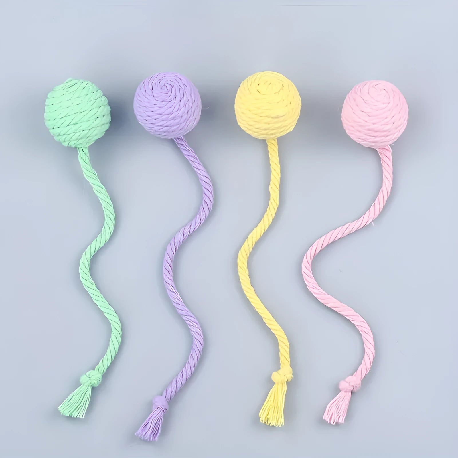 Colourful cat toy ball with rope attachment and internal bell for interactive kitten play