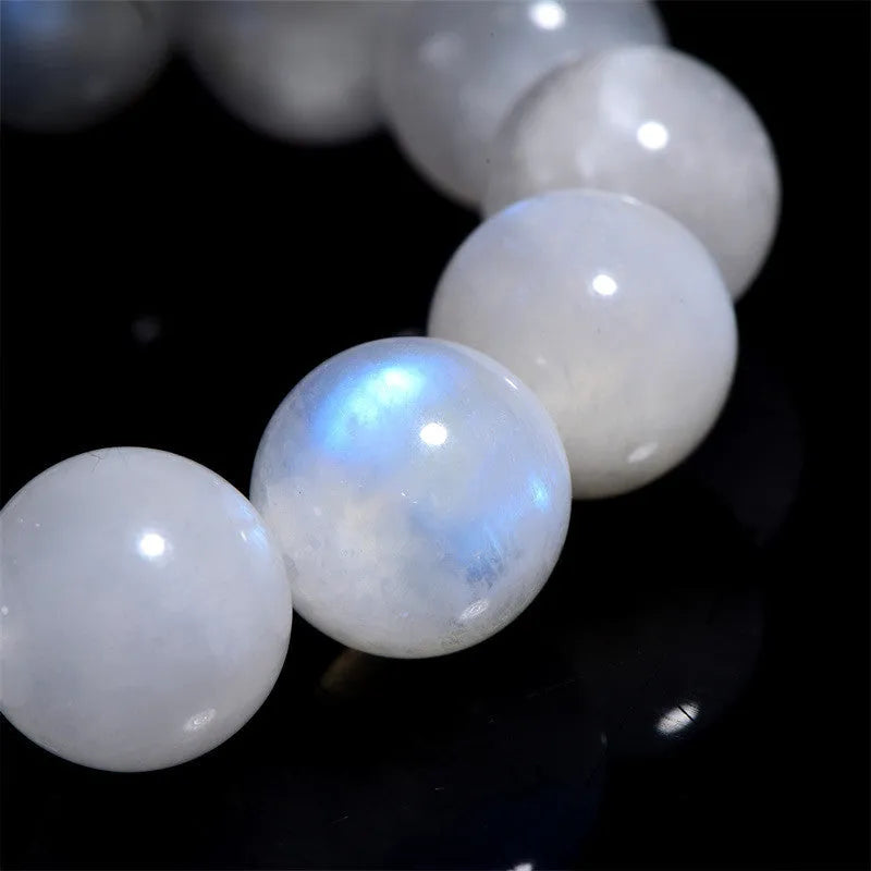 Natural white moonstone round bead bracelet showing blue moonlight sheen and polished surface