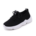 Women's white sport shoes with thick rubber soles and woven upper fabric with front strap closure