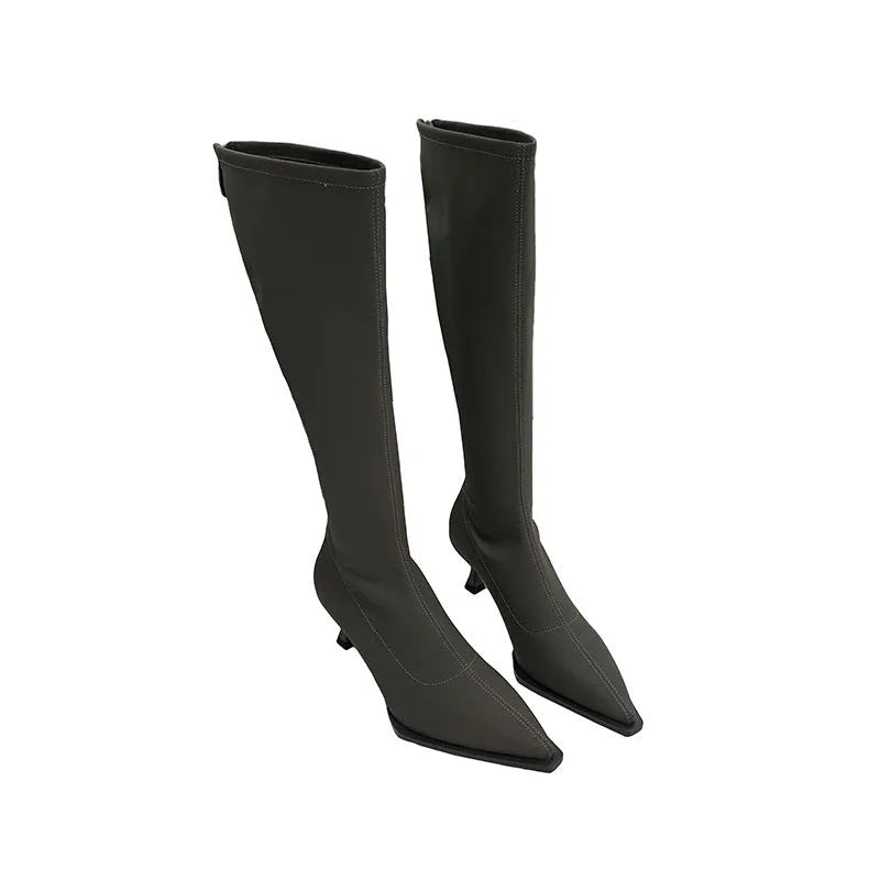 Black women's pointed toe below-the-knee boots with a stiletto heel and a back zipper closure on the side.