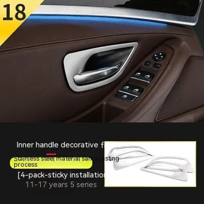 Set of four silver and black decorative trim strips for BMW 5 Series interior door handles.