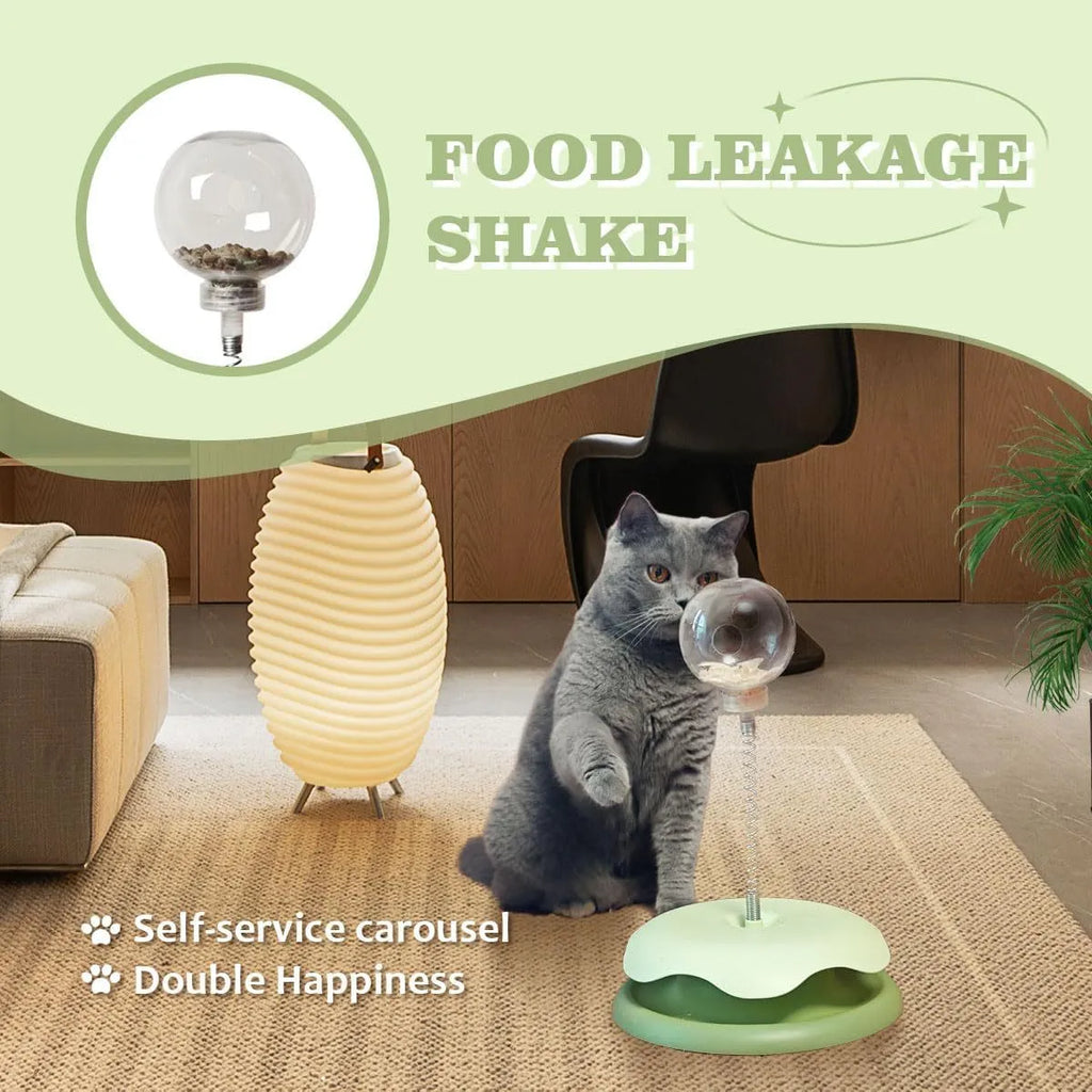 Blue and green interactive cat treat dispenser toy with track ball on flat surface
