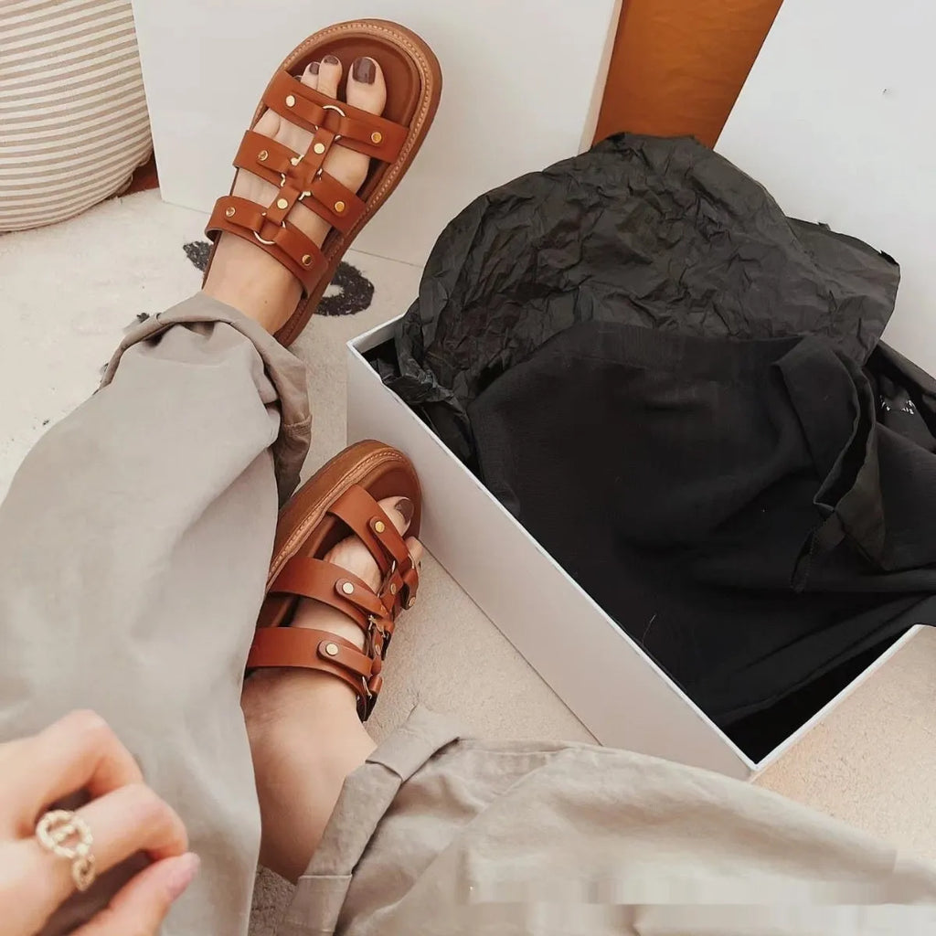 Women's black retro Roman gladiator sandal slippers made from patent leather and sheepskin.