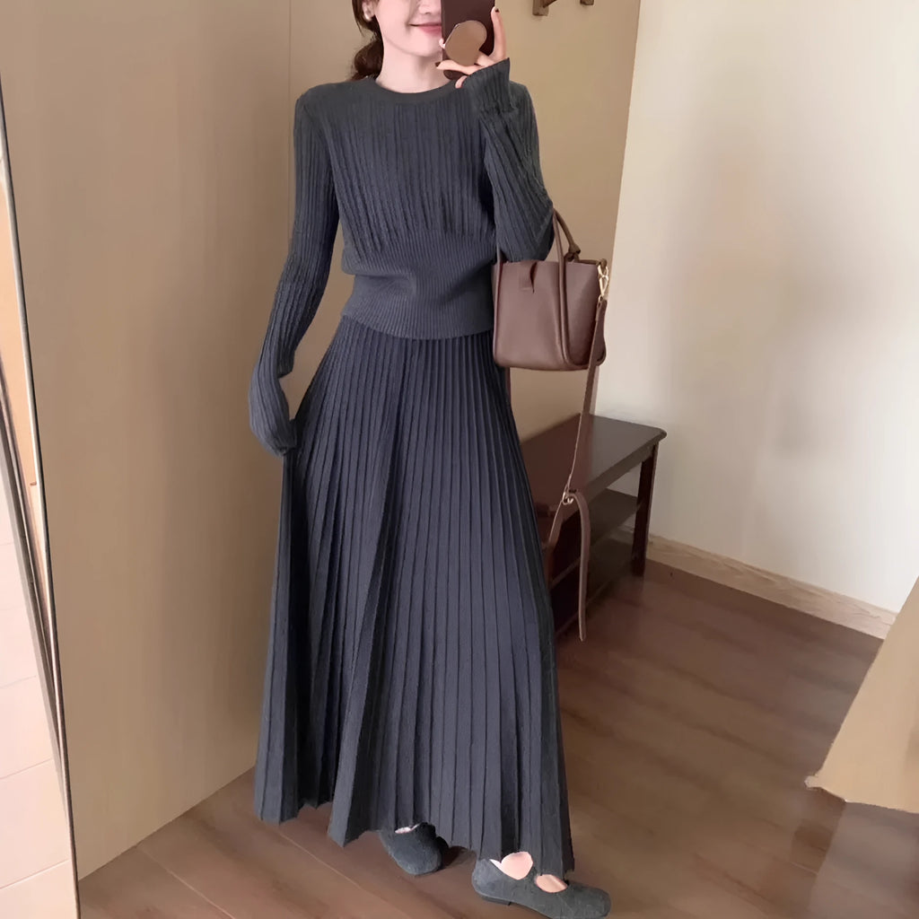 Women's knitted ethnic style dress suit with skirt showing 3D patterns in dark grey colour